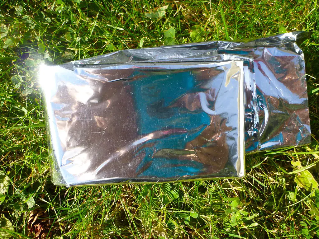 Use a Mylar Blanket to keep tent warm without electricity