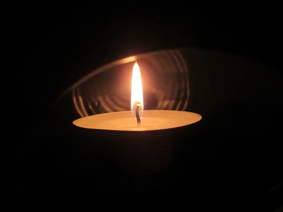 Use a candle for how to stay warm in a tent without electricity