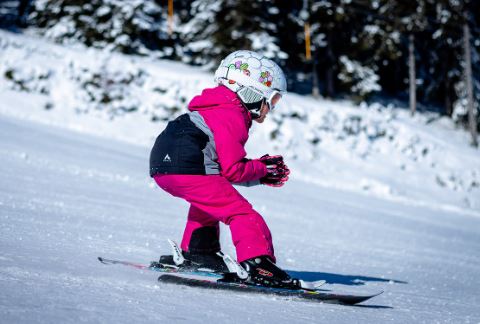 child skiing with layers