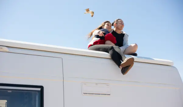 couple on top of rv