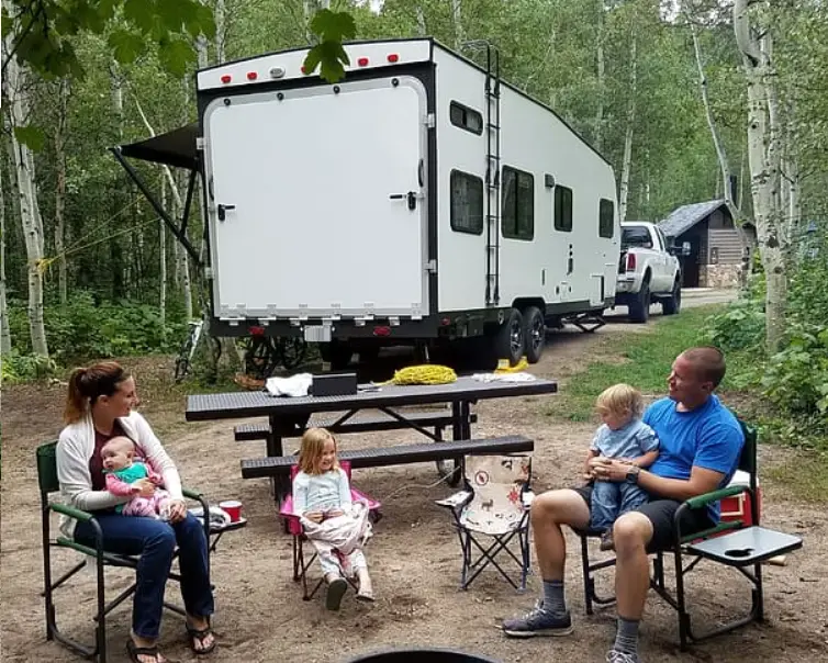 family in front of camper