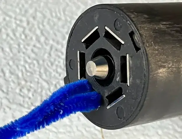 cleaning a trailer plug with pipe cleaners